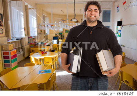 Smiling young man in elementary classroom 3630324