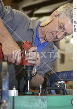 worker and hand drill worker and hand drill 3663159