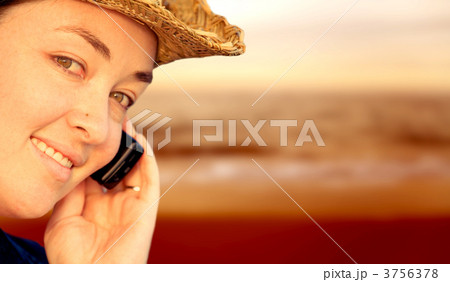 Girl on mobile phone by the beach Girl on mobile phone by the beach 3756378
