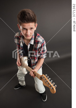 Young male posing with a guitar 3771362