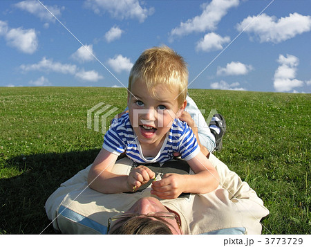 son lie on ather on green grass son lie on ather on green grass 3773729