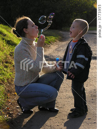 mother with son on sundown with soapy bubble 3773955