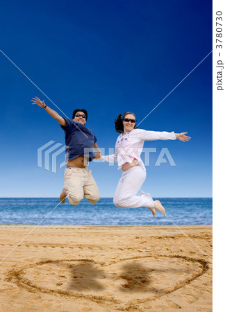 beach couple jumping of joy beach couple jumping of joy 3780730
