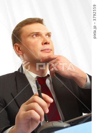 The businessman in a suit behind a table. 3792559