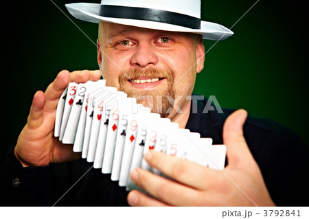 man skilfully shuffles playing cards 3792841