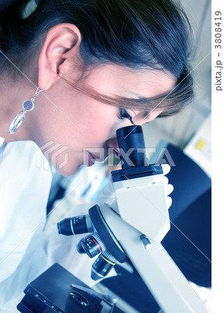 doctor looking under a microscope 3808419