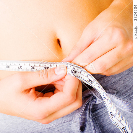 Young Woman Measuring Herself On White 3824504