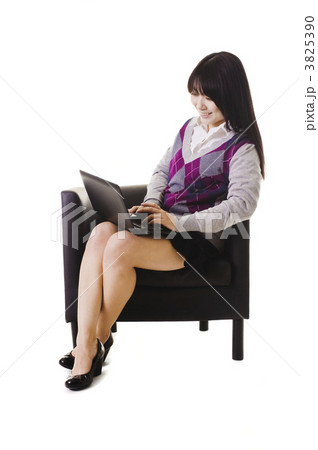 Chinese student working on a laptop and sitting in a chair. 3825390