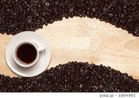 Dark Roasted Coffee Beans and Cup on Wood Background Dark Roasted Coffee Beans and Cup on Wood Background 3864963