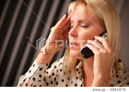 Blonde Woman on Cell Phone with Stressed Look 3865076