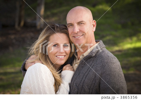 Attractive Couple Wearing Sweaters in Park 3865356