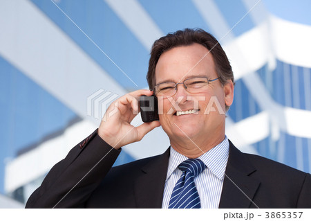 Businessman Smiles as He Talks on His Cell Phone 3865357