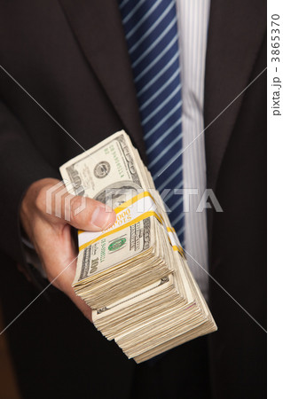 Businessman Handing Over Stack of Cash 3865370