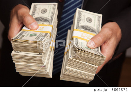 Businessman Handing Over Stacks of Money 3865372