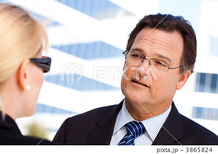 Businessman Talking with Female Colleague 3865824