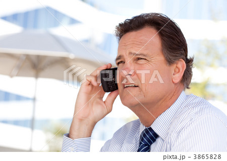 Businessman Smiles as He Talks on His Cell Phone Businessman Smiles as He Talks on His Cell Phone 3865828