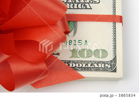 One Hundred Dollar Bills Wrapped in Red Ribbon. 3865834
