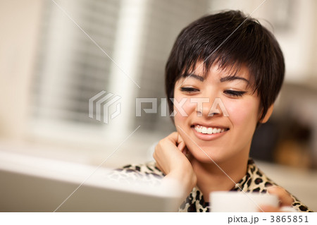 Pretty Smiling Multiethnic Woman Using Laptop Pretty Smiling Multiethnic Woman Using Laptop 3865851
