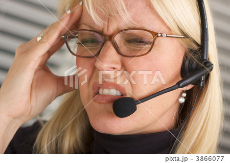 Businesswoman with Phone Headset and Headache 3866077