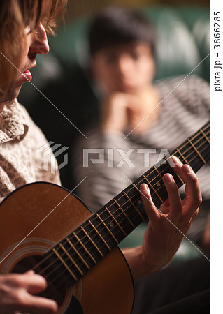 Young Musician Plays His Acoustic Guitar as Friend Listens 3866285