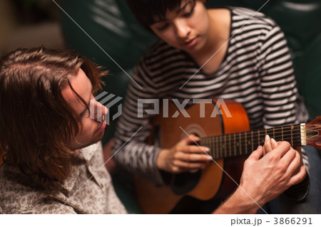 Young Musician Teaches Female Student To Play the Guitar Young Musician Teaches Female Student To Play the Guitar 3866291