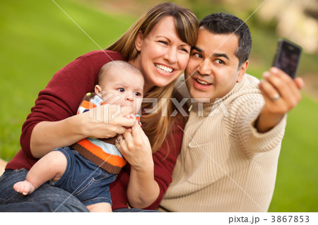 Happy Mixed Race Parents and Baby Boy Taking Self Portraits 3867853