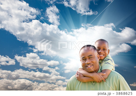 Happy African American Man with Child Over Clouds and Sky 3868625