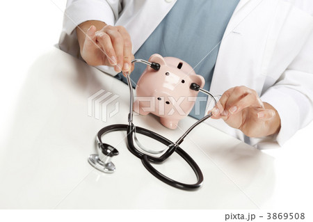 Doctor Holds Stethoscope to Ears of Pink Piggy Bank Doctor Holds Stethoscope to Ears of Pink Piggy Bank 3869508