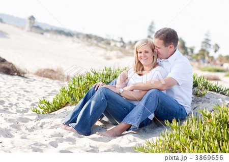 Attractive Caucasian Couple Relaxing at the Beach Attractive Caucasian Couple Relaxing at the Beach 3869656