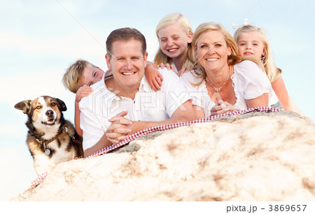 Happy Caucasian Family and Dog Portrait at the Beach Happy Caucasian Family and Dog Portrait at the Beach 3869657