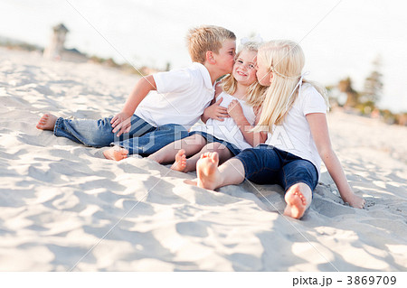 Adorable Sibling Children Kissing the Youngest Adorable Sibling Children Kissing the Youngest 3869709