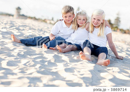 Adorable Sisters and Brother Having Fun at the Beach Adorable Sisters and Brother Having Fun at the Beach 3869714
