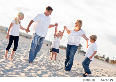 Adorable Little Girl Swinging with Her Parents Adorable Little Girl Swinging with Her Parents 3869739