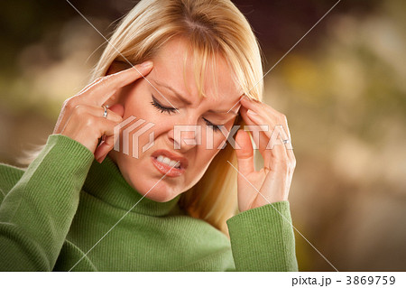 Grimacing Woman Suffering a Headache 3869759