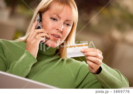 Cheerful Woman on Phone and Laptop with Credit Card 3869776