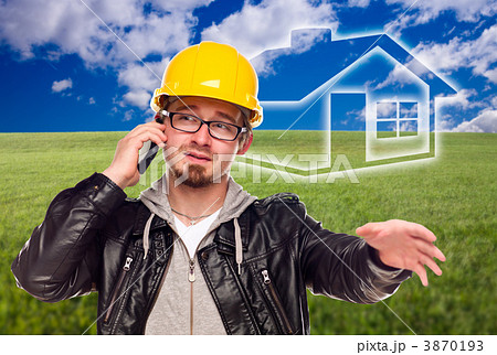 Contractor in Hard Hat in Front of Ghosted House and Grass Field Contractor in Hard Hat in Front of Ghosted House and Grass Field 3870193