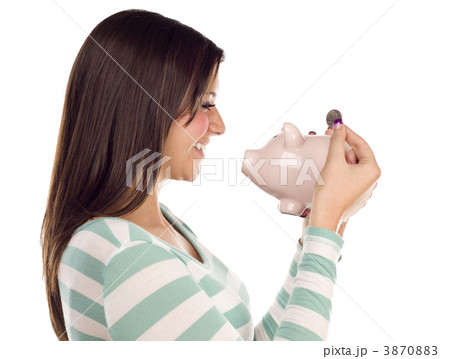 Ethnic Female Putting Coin Into Piggy Bank on White 3870883