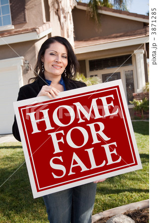Hispanic Woman Holding Real Estate Sign In Front of House Hispanic Woman Holding Real Estate Sign In Front of House 3871285