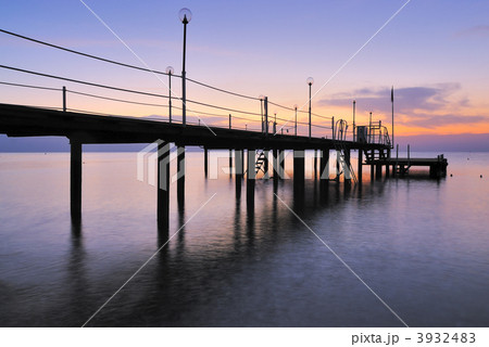 Pier silhouette over sunrise glow 3932483
