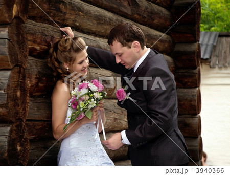 young wedding couple alone near wood house young wedding couple alone near wood house 3940366