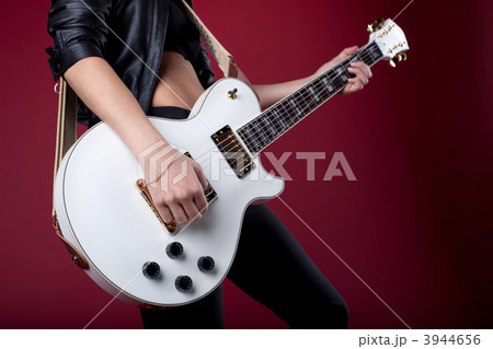 rock woman in black leather posing with guitar rock woman in black leather posing with guitar 3944656