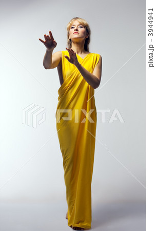 Blond woman in yellow veil play role Blond woman in yellow veil play role 3944941