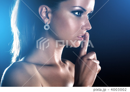 Young woman showing quiet handsign Young woman showing quiet handsign 4003002