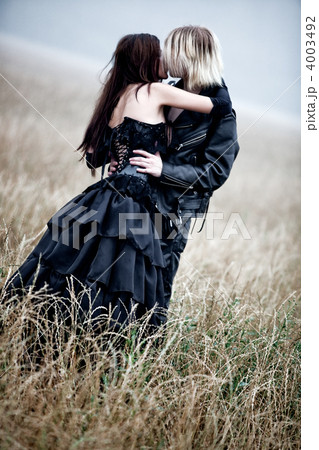 Young goth couple kissing outdoors 4003492