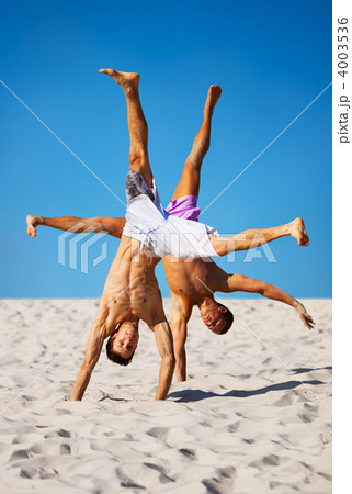 Two sportsmans on beach Two sportsmans on beach 4003536