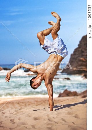 Young sportsman on beach 4003557