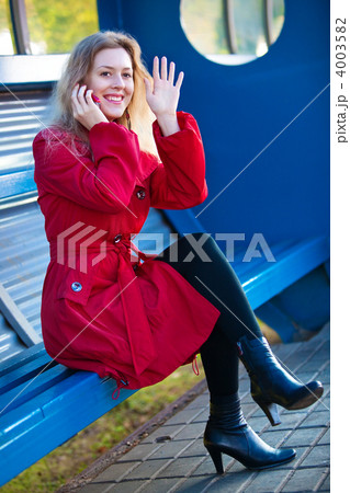 Young woman sitting on station stop 4003582