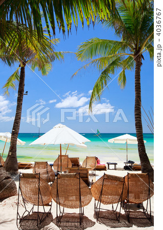 Wooden beach chairs on exotic beach 4036767
