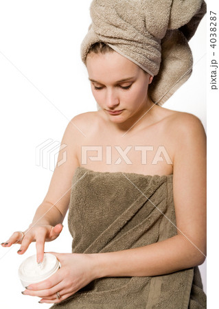 Young woman appying some creme 4038287