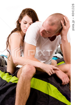 Couple comforting each other sitting on the side of the bed Couple comforting each other sitting on the side of the bed 4041326